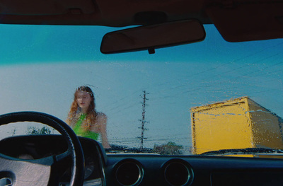 a woman sitting in the driver's seat of a car