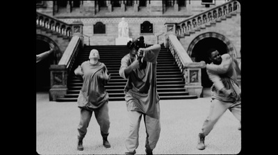 a group of men standing next to each other in front of a building