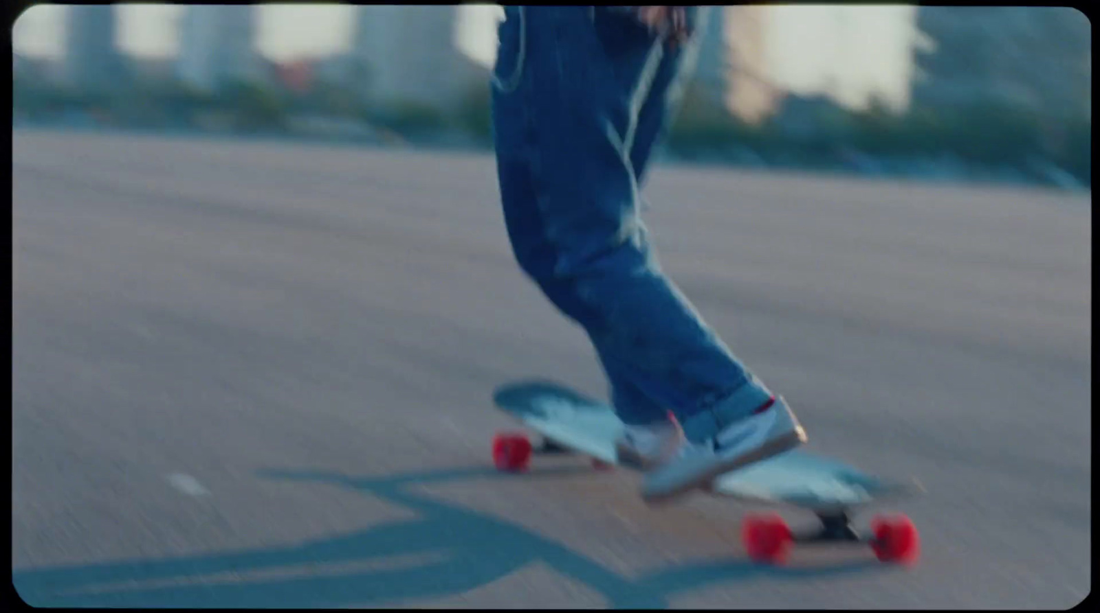 a person riding a skateboard down a street