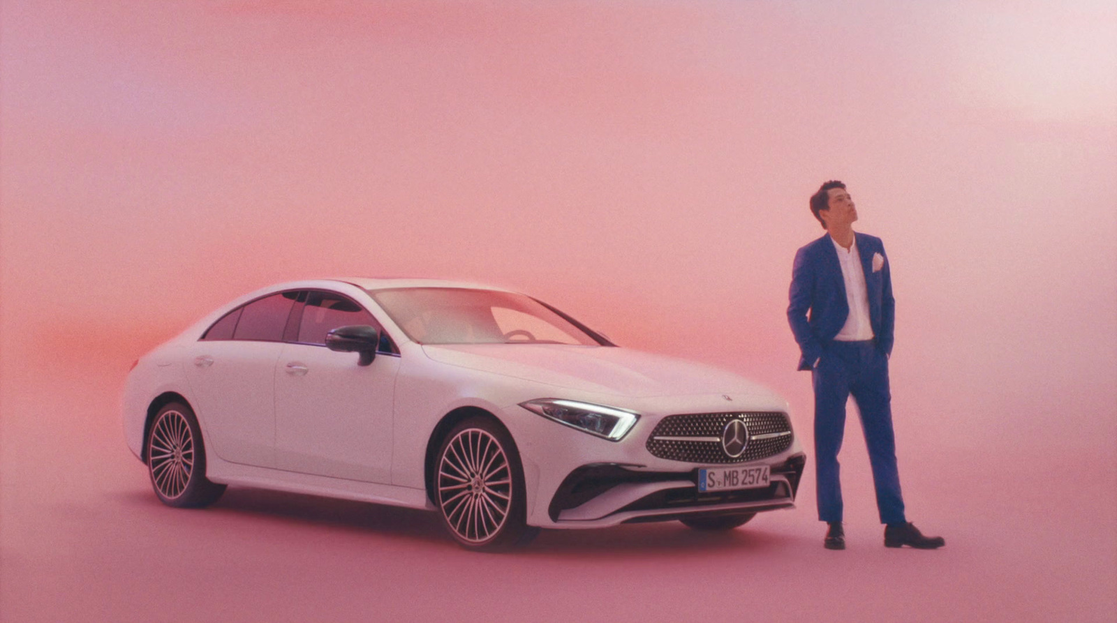 a man standing next to a white car