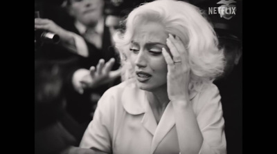 a black and white photo of a woman covering her eyes