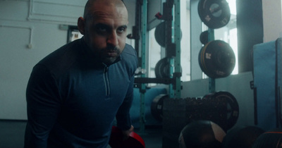 a man in a gym with boxing gloves