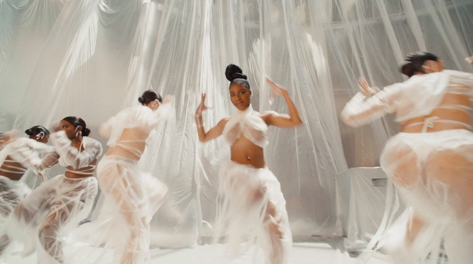 a group of women in white dresses dancing