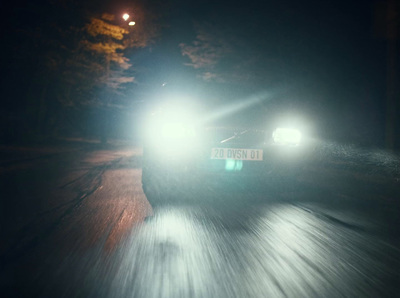 a car driving down a road at night