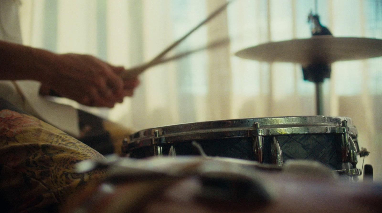 a person playing drums in front of a drum set