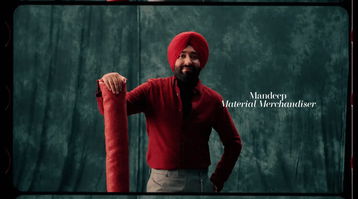 a man in a red turban holding a red object