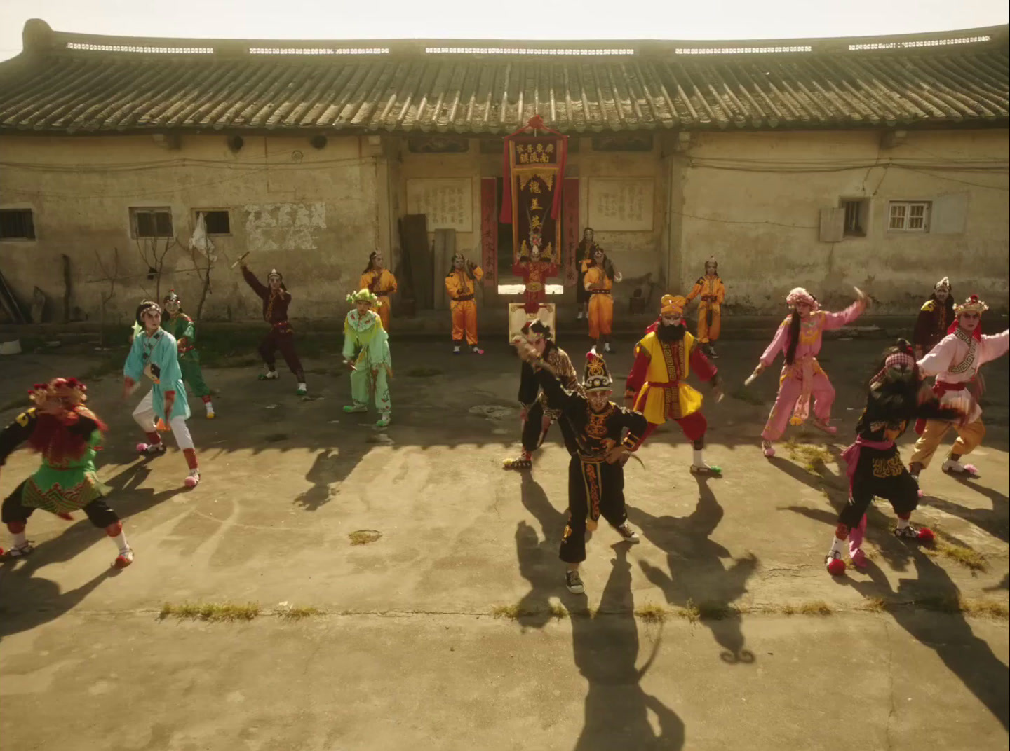 a group of people dancing in front of a building