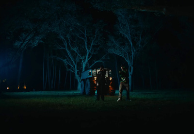 a group of people standing in a field at night