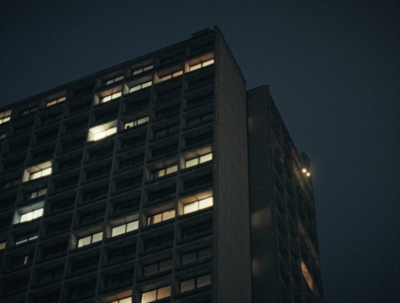 a tall building lit up at night time