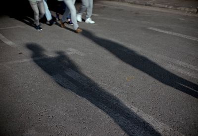 a group of people standing in a parking lot