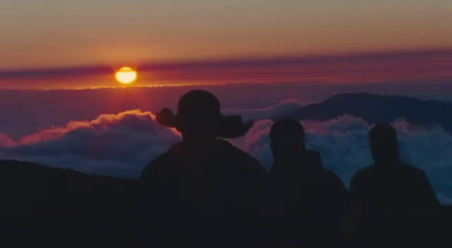 a group of people standing on top of a mountain