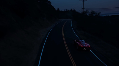 a car driving down a road at night