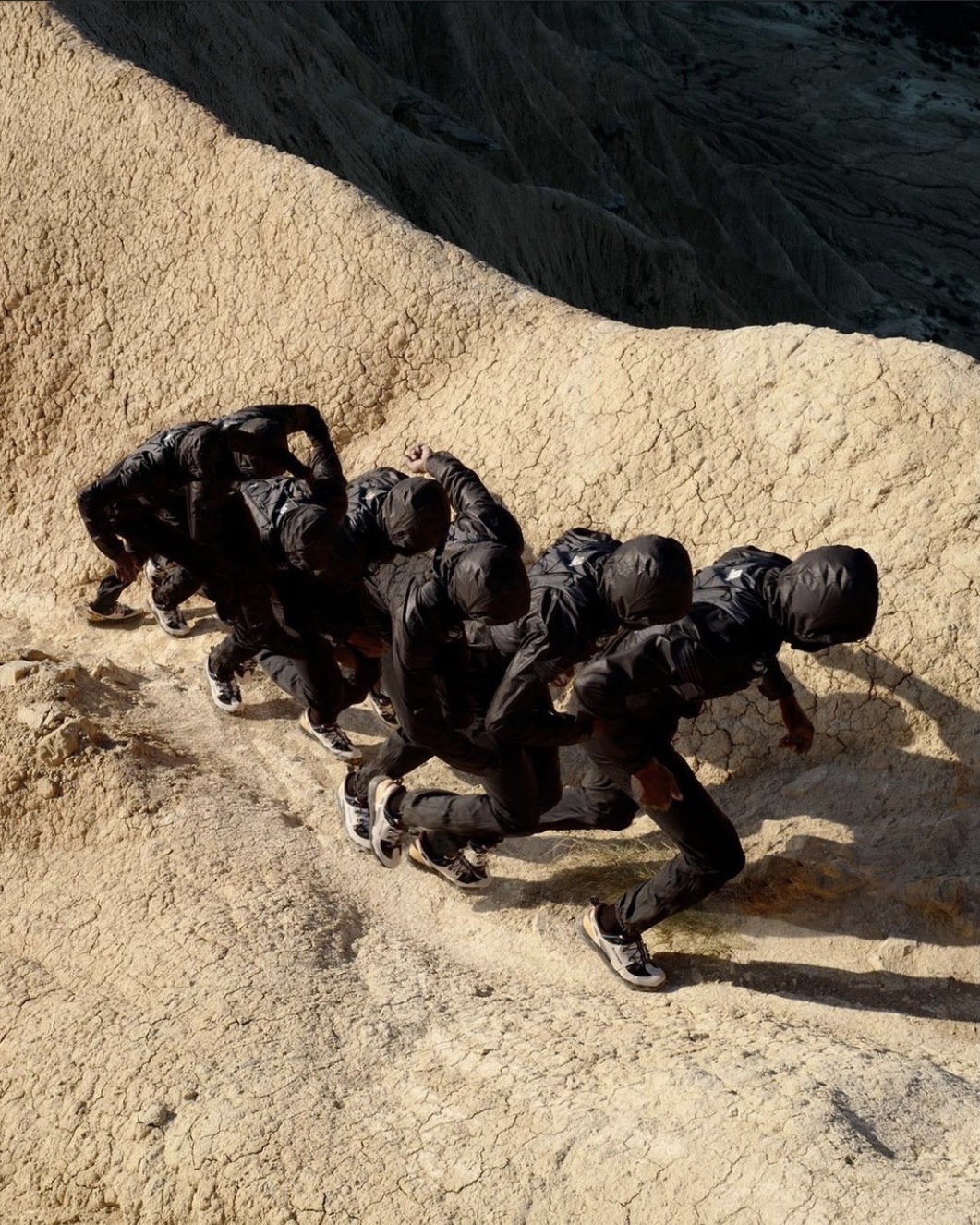 a group of people climbing up the side of a mountain