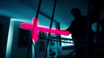 a man standing on a ladder in a dark room