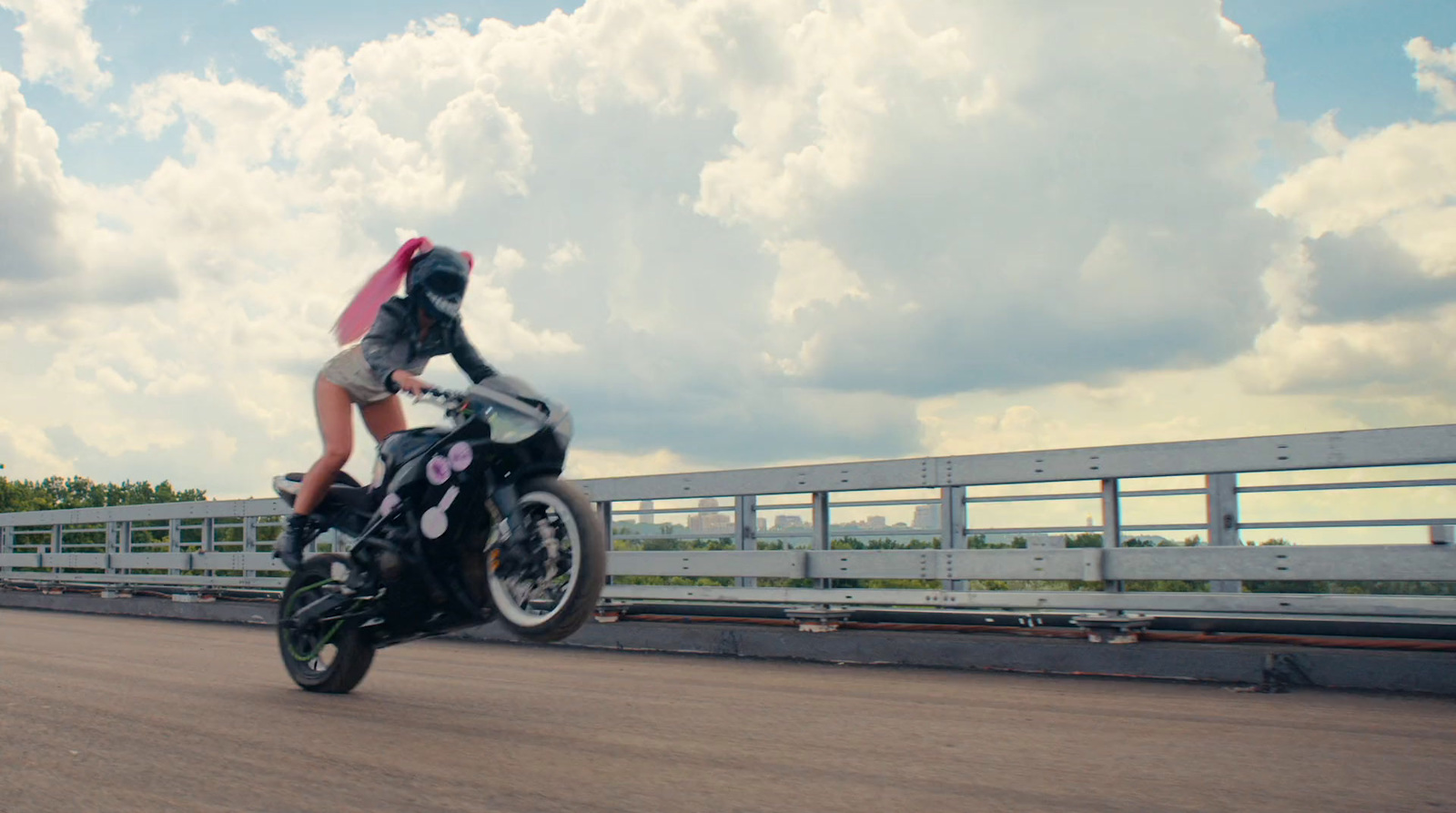 a person riding a motorcycle on a bridge