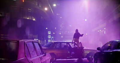 a person on a bike on a city street at night