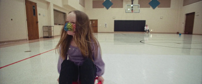 a girl with long hair is holding a frisbee