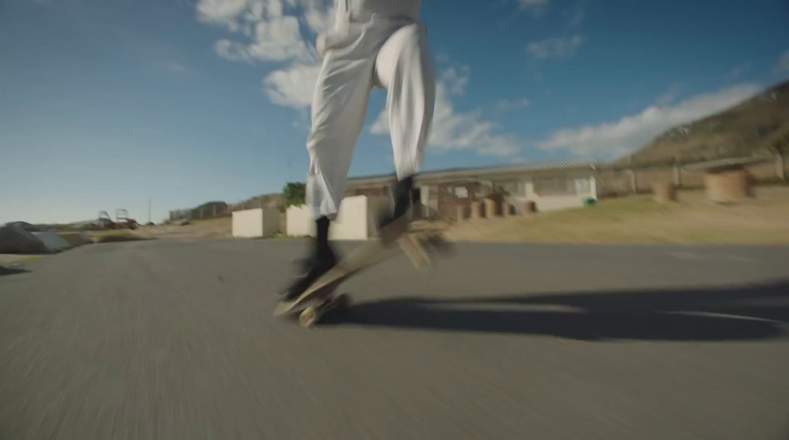 a person riding a skateboard down a street