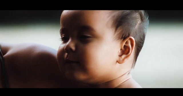 a close up of a person holding a baby