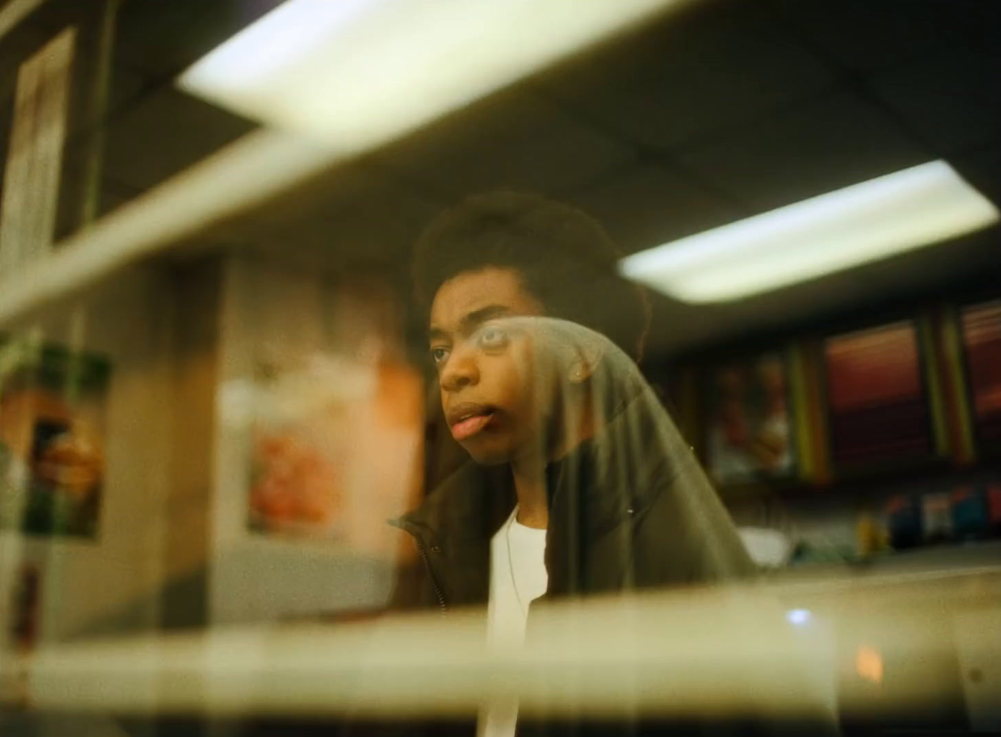 a woman looking through a window at something