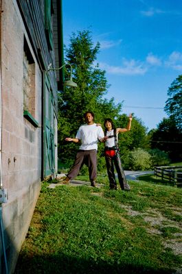 a man and a woman standing in front of a building