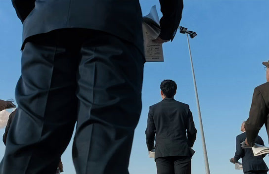 a group of men walking down a street next to each other