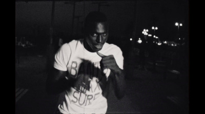 a black and white photo of a man in a t - shirt