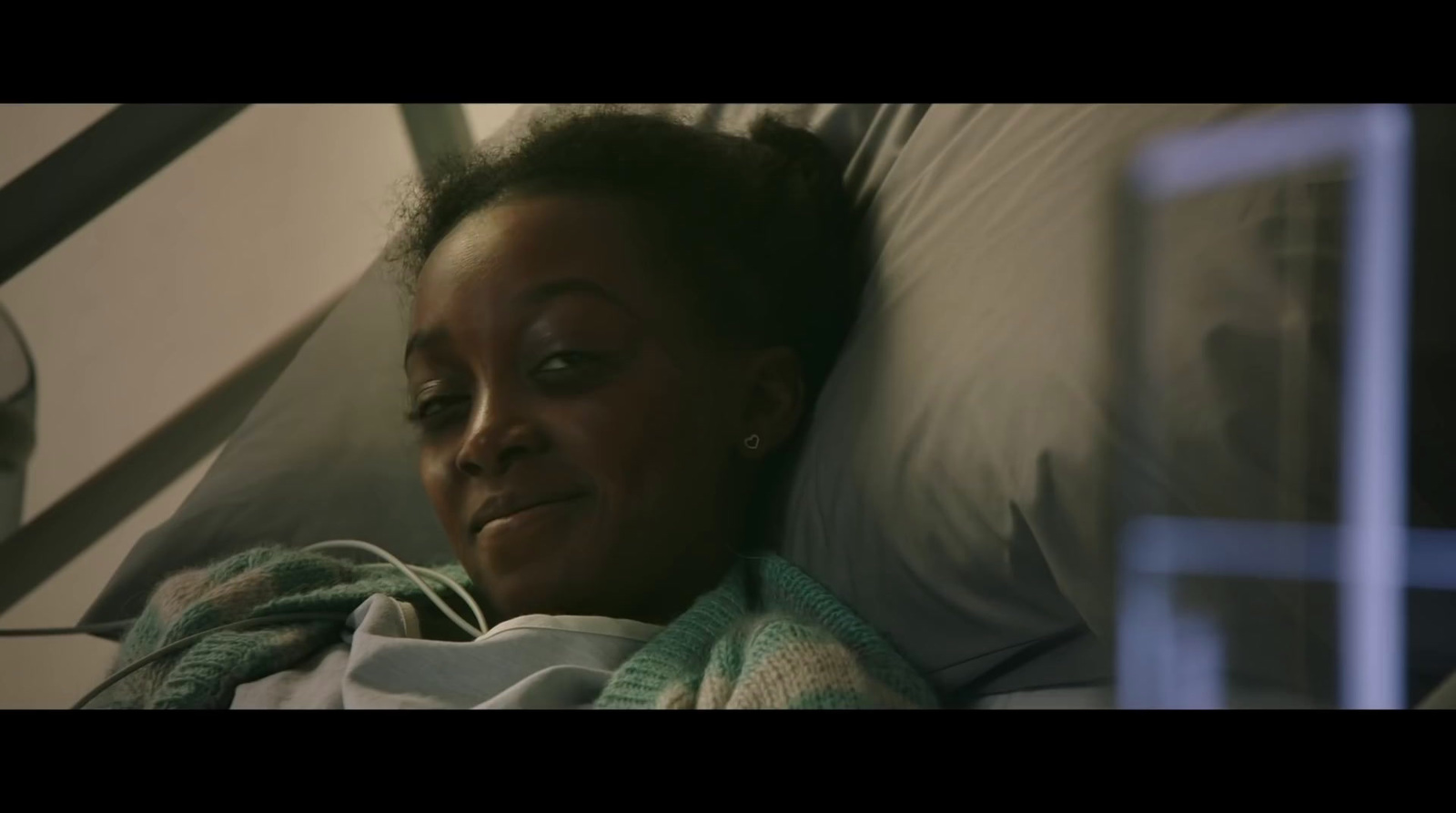 a woman laying in a hospital bed with her eyes closed