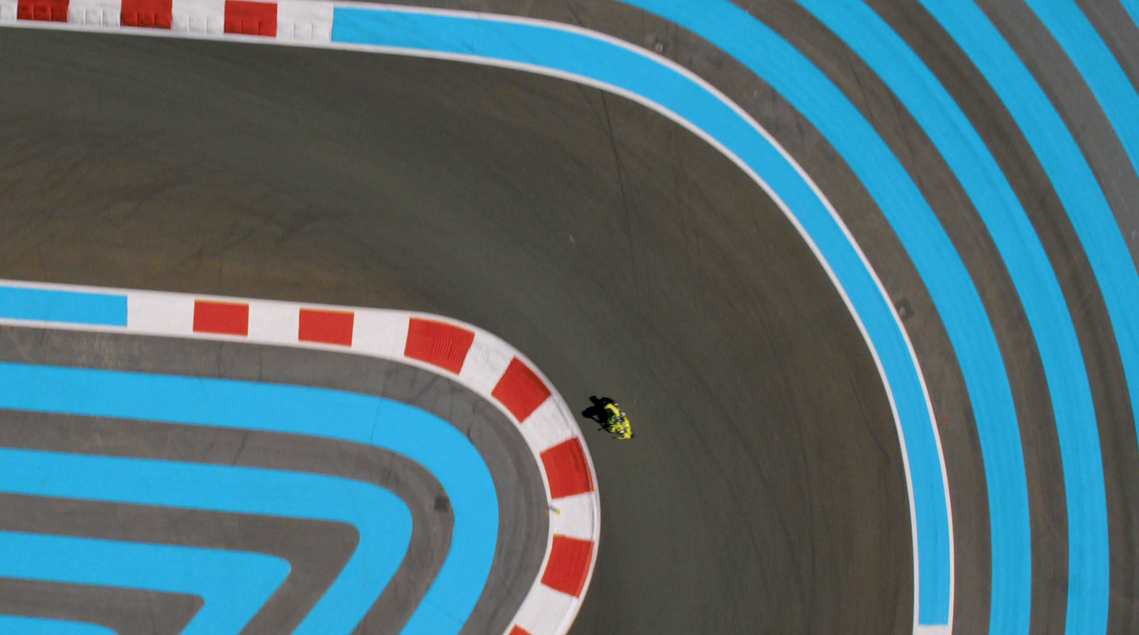 a person riding a motorcycle on a race track