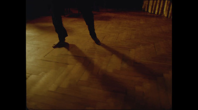 a person standing on a hard wood floor