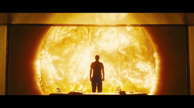 a man standing in front of a giant sun