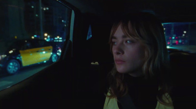 a woman sitting in a car at night