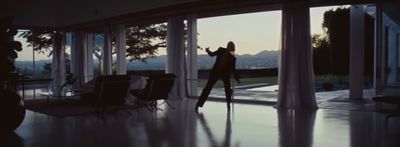 a woman standing in front of a glass door