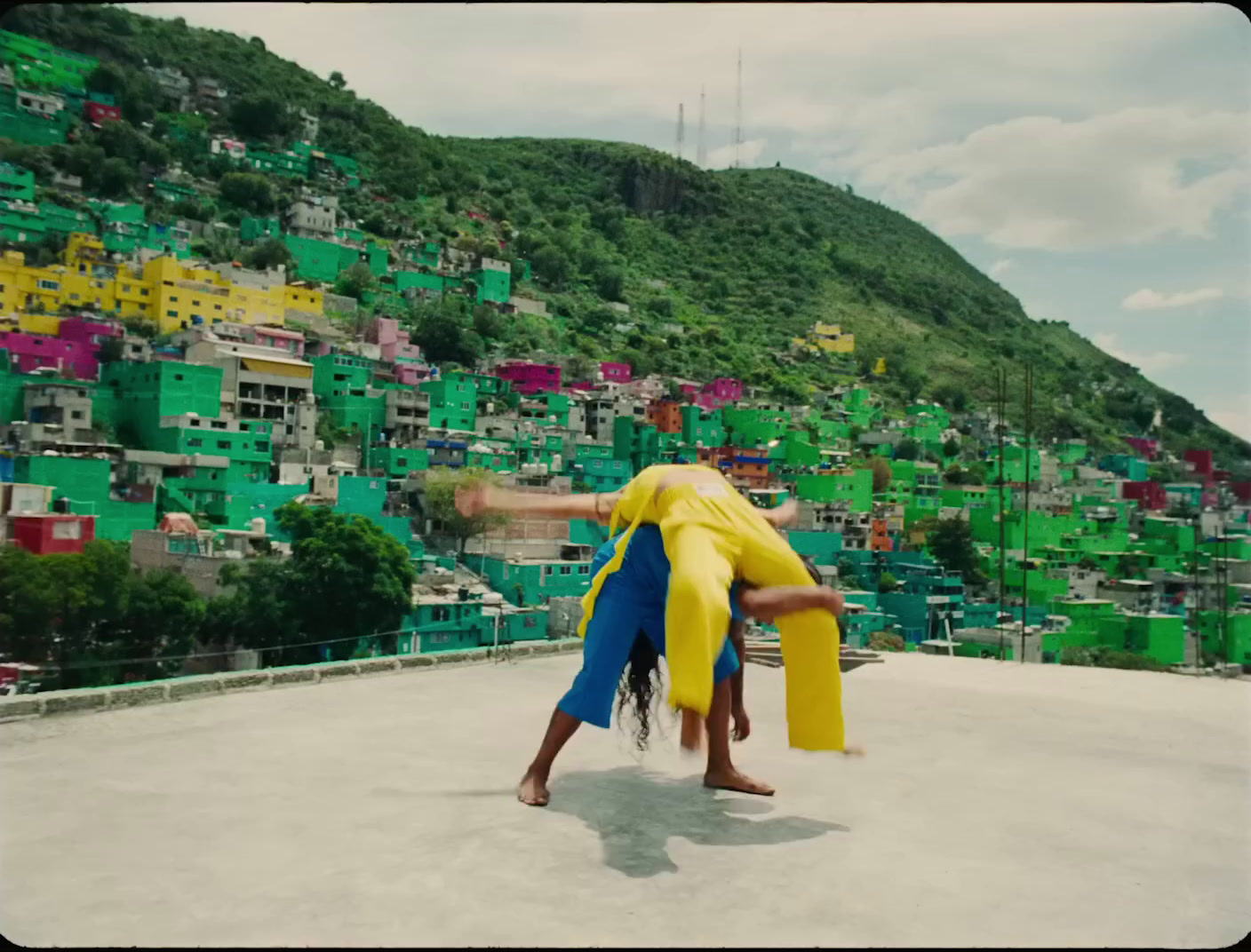 a person doing a handstand in front of a mountain