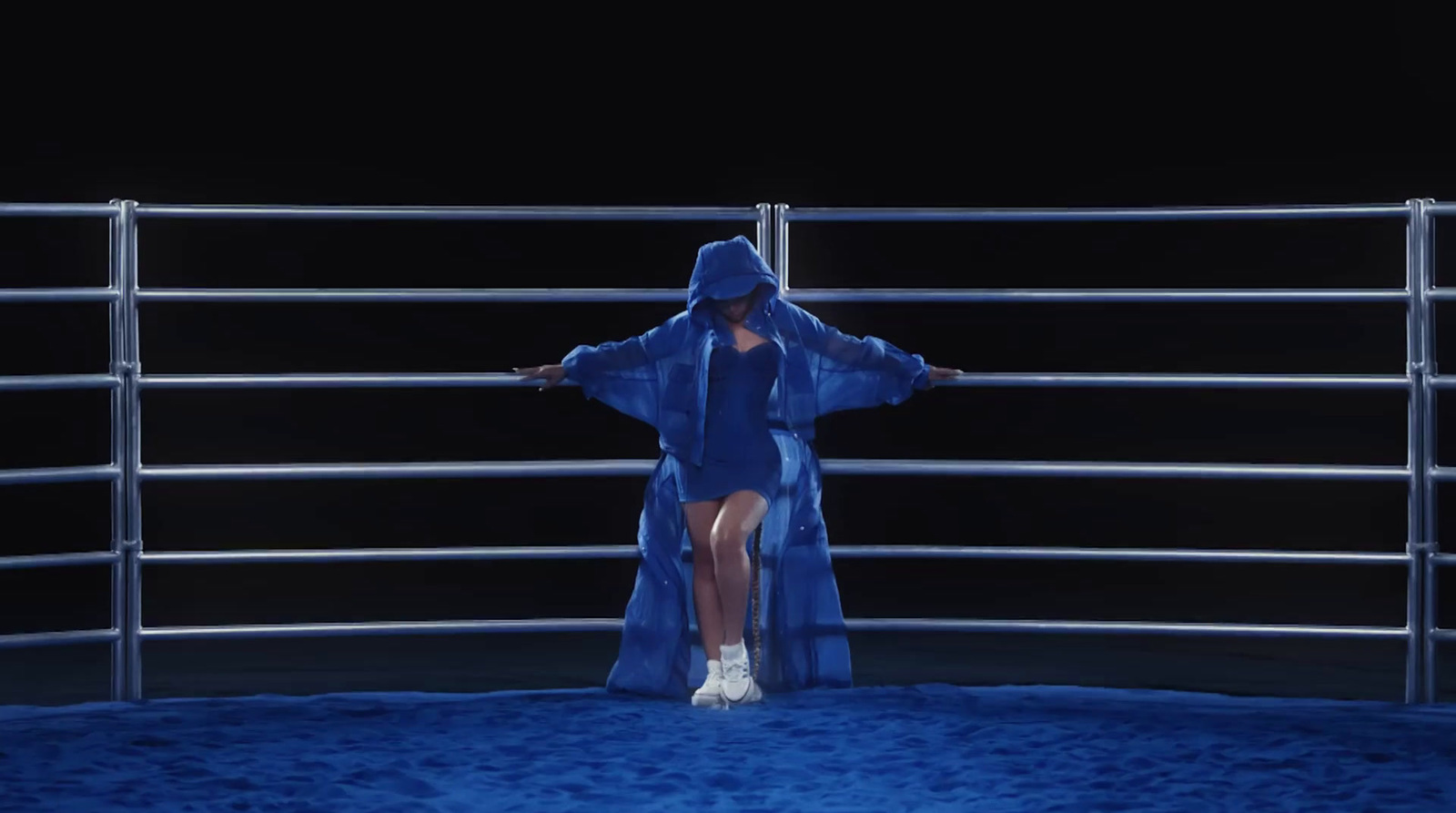 a woman in a blue robe standing in a boxing ring