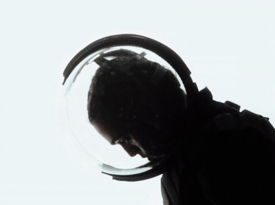 a man in a space suit looking through a magnifying glass