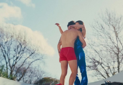 a couple of people that are standing on a skateboard