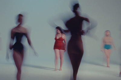 a group of women in swimsuits standing next to each other