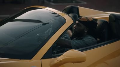 a man sitting in a yellow sports car