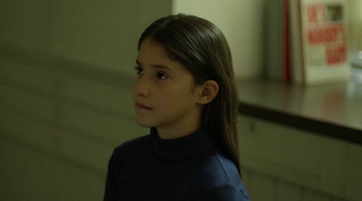 a young girl in a black turtle neck shirt