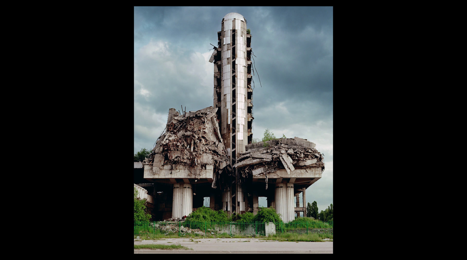 a very tall building with a bunch of debris on top of it