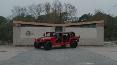 a red jeep parked in front of a building