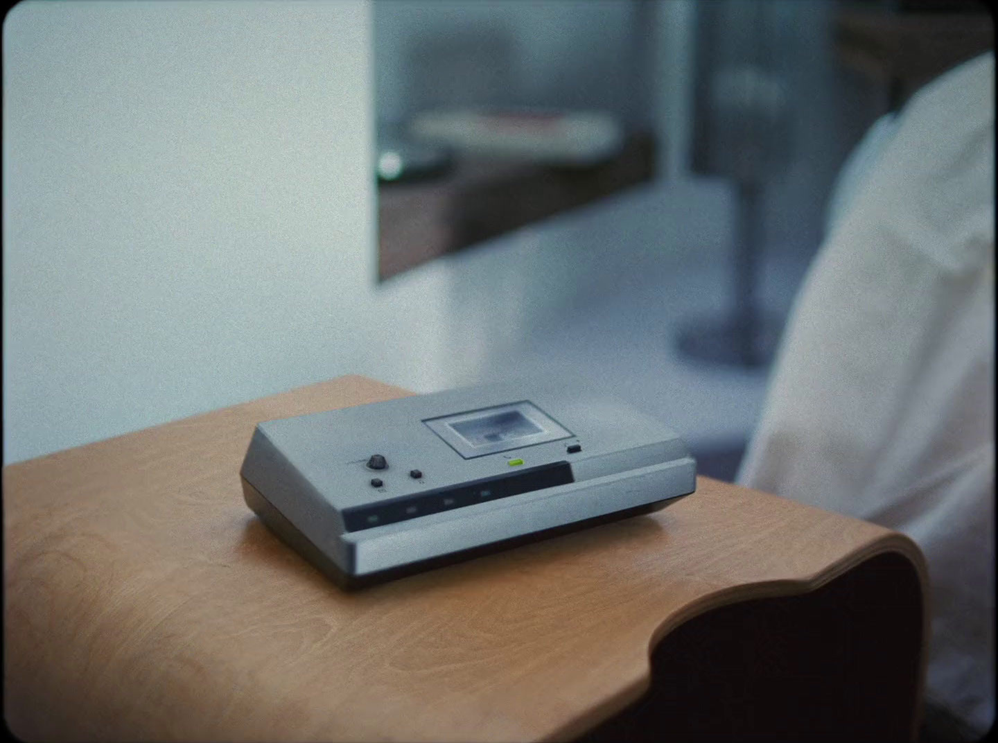 a small electronic device sitting on top of a wooden table