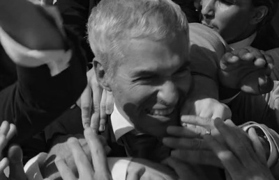 a black and white photo of a man holding a baby