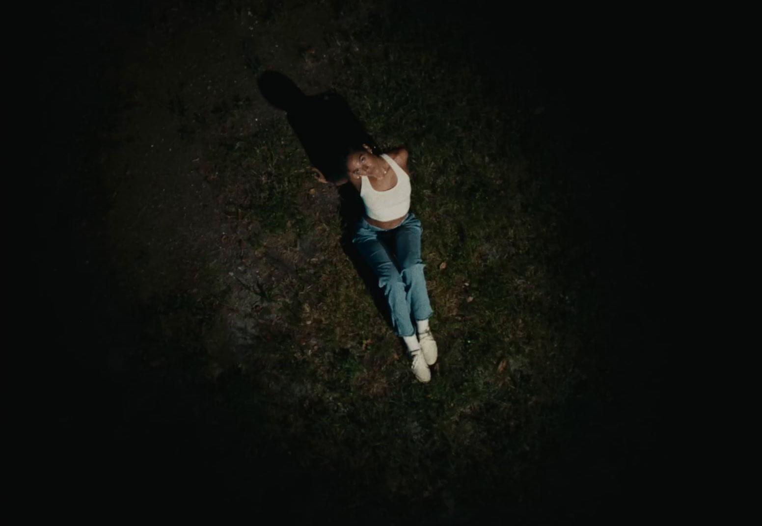 a person laying on the ground in the dark