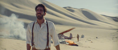 a man with suspenders and suspenders standing in the desert