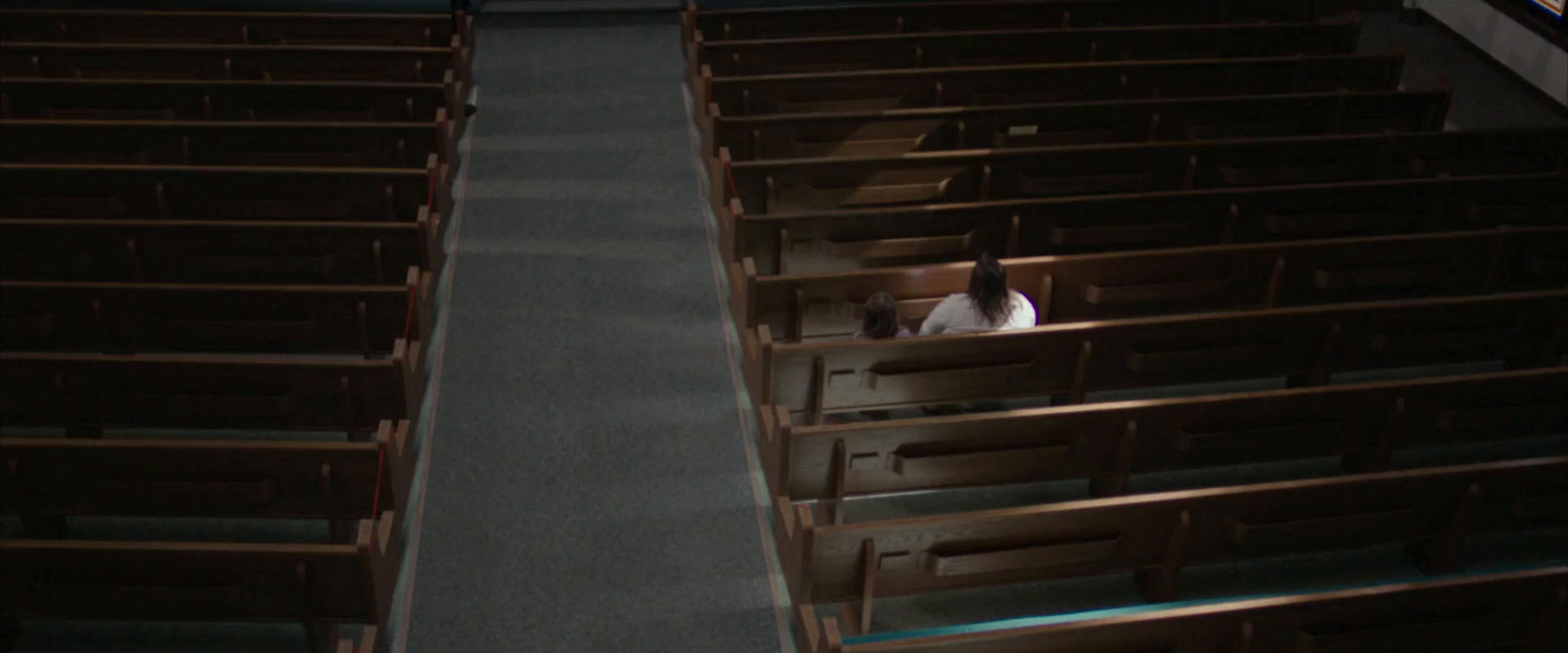 a couple of people sitting in chairs in a church