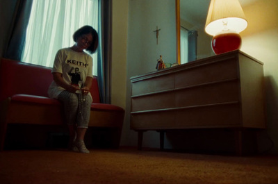 a woman sitting on a red chair in a room