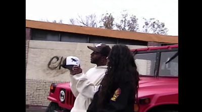 a man and a woman standing in front of a red truck