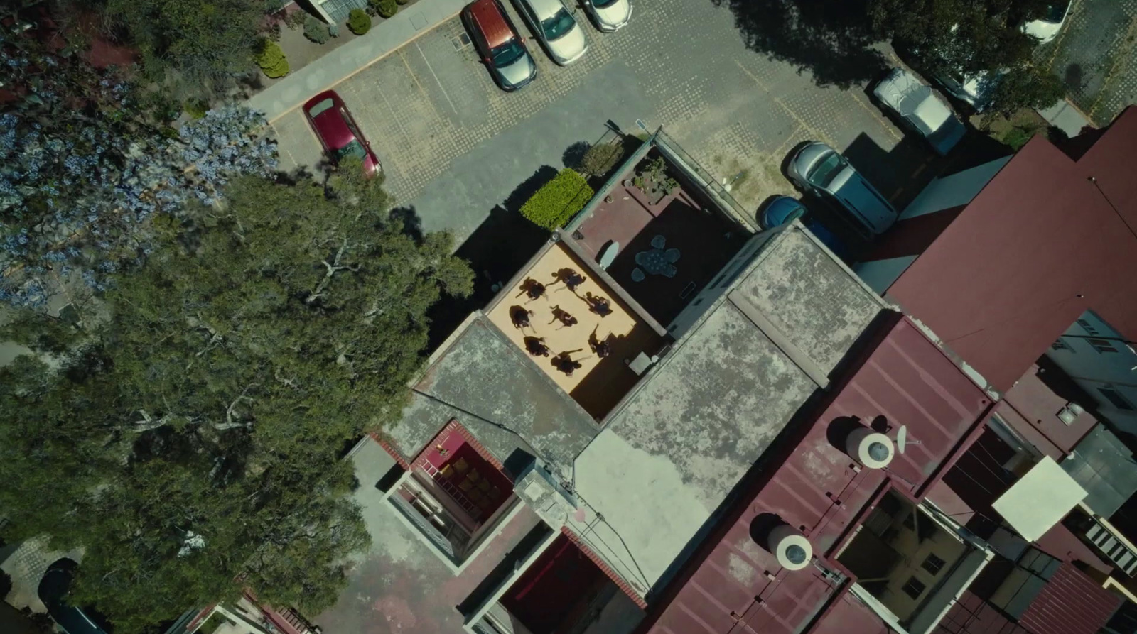 an aerial view of a parking lot with cars parked in it